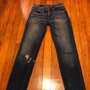 Distressed dark wash jeans